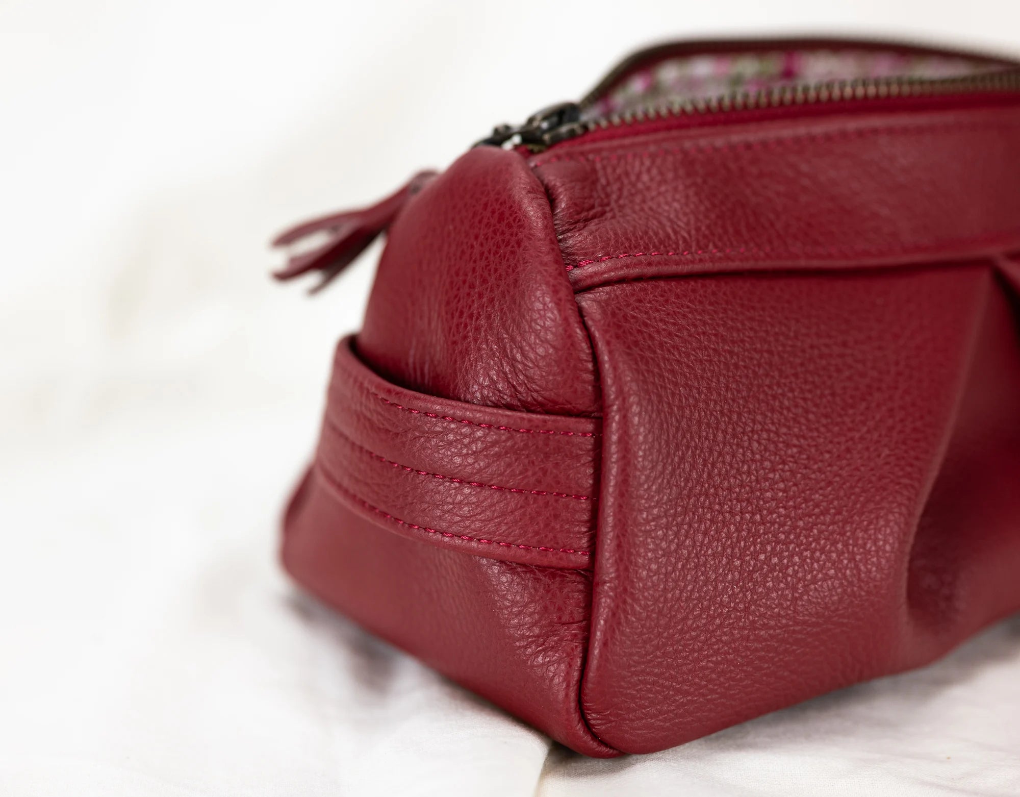 Red leather bag with a zipper on a white background