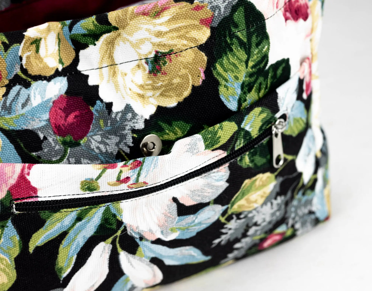Floral-patterned clutch bag on a white background
