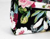 Floral patterned bag with a strap on a light gray background