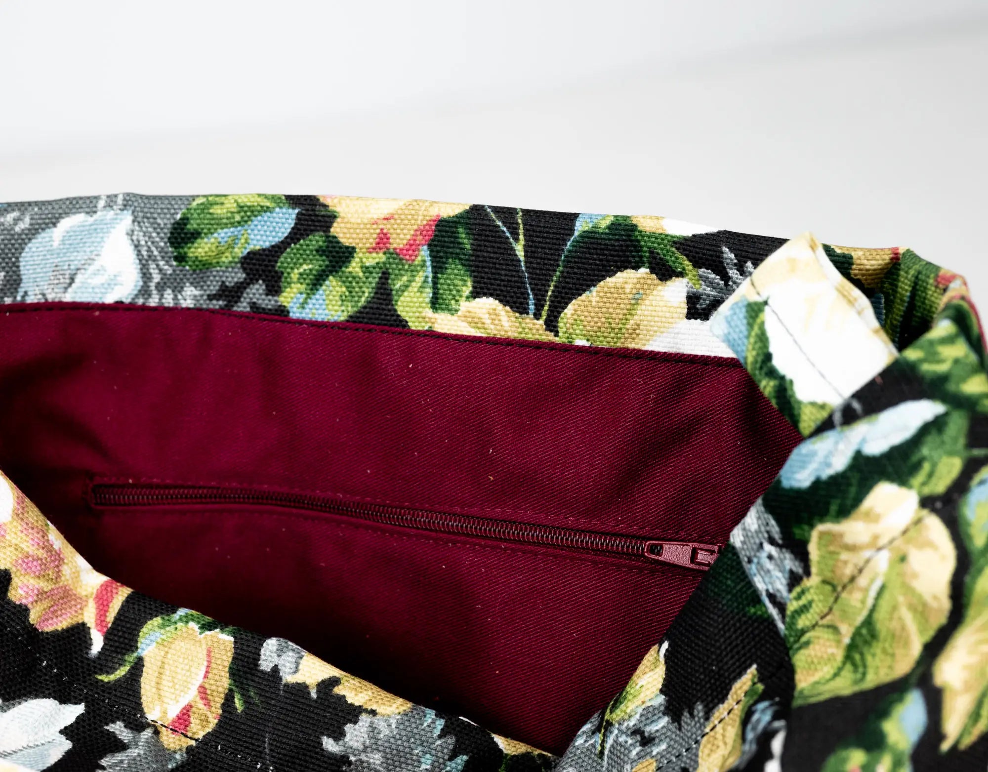 Floral-patterned fabric with a zipper on a white background