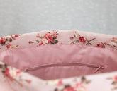 Floral-patterned cushion with a zipper on a light gray background