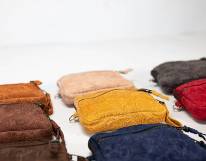 Collection of colorful textured pouches on a white background