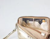 Gold wallet with cards on a light gray background