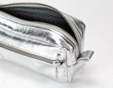 Silver metallic pouch with a zipper on a white background