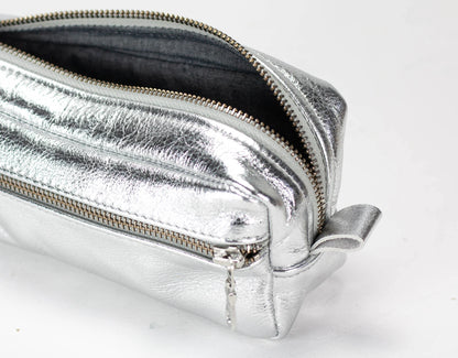 Silver metallic pouch with a zipper on a white background
