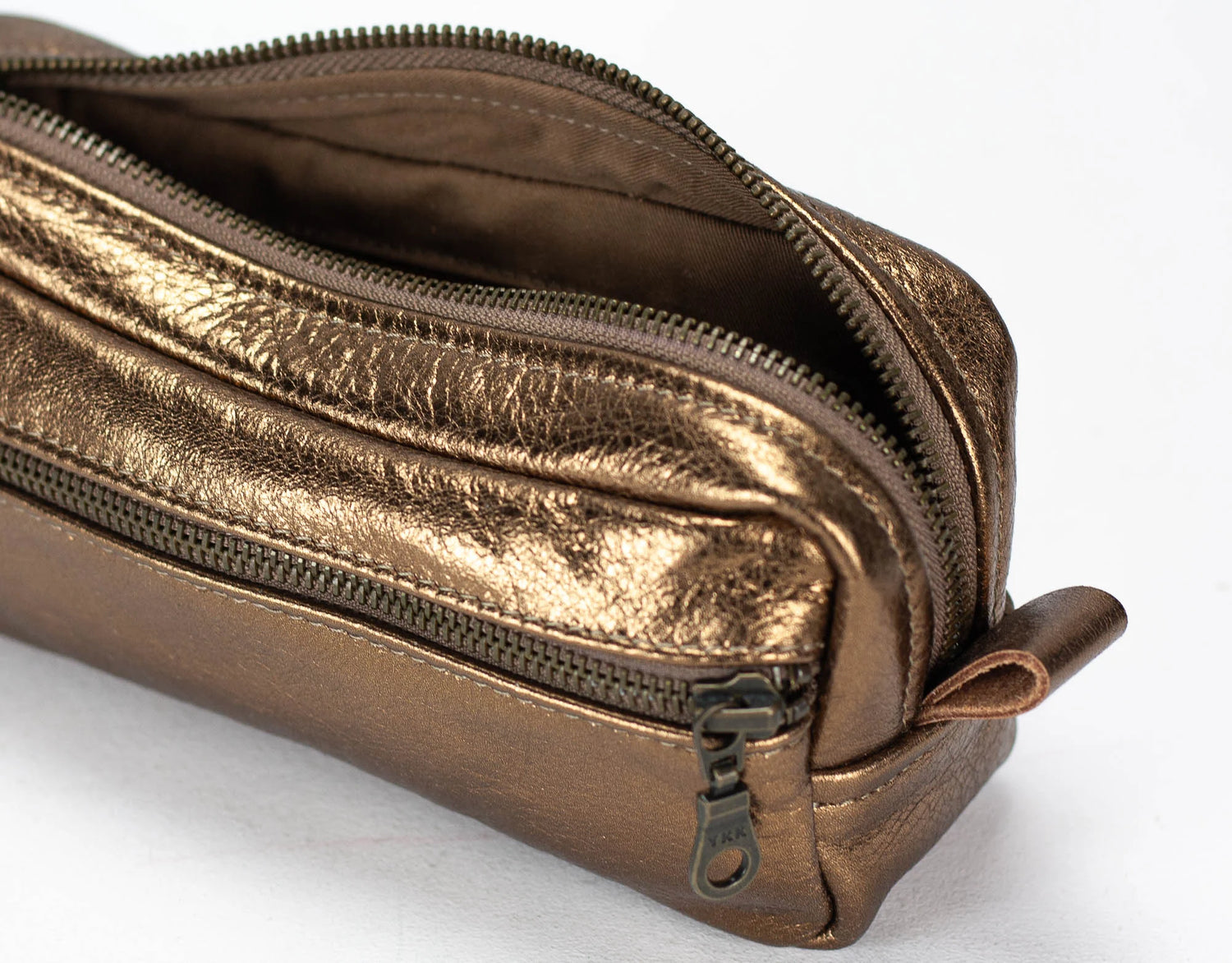 Bronze-colored zippered pouch on a white background