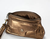 Bronze metallic handbag with a wrist strap on a white background