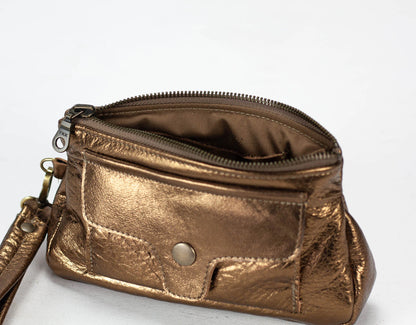 Bronze metallic handbag with a wrist strap on a white background