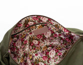 Floral-patterned lining of a bag with a visible brand label on a white background
