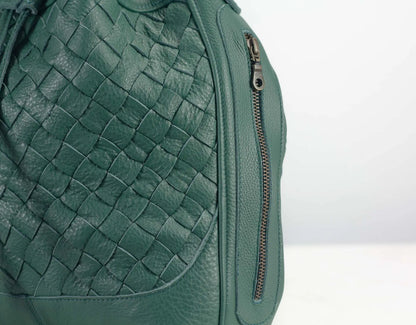 Green woven leather bag with a zipper on a light gray background