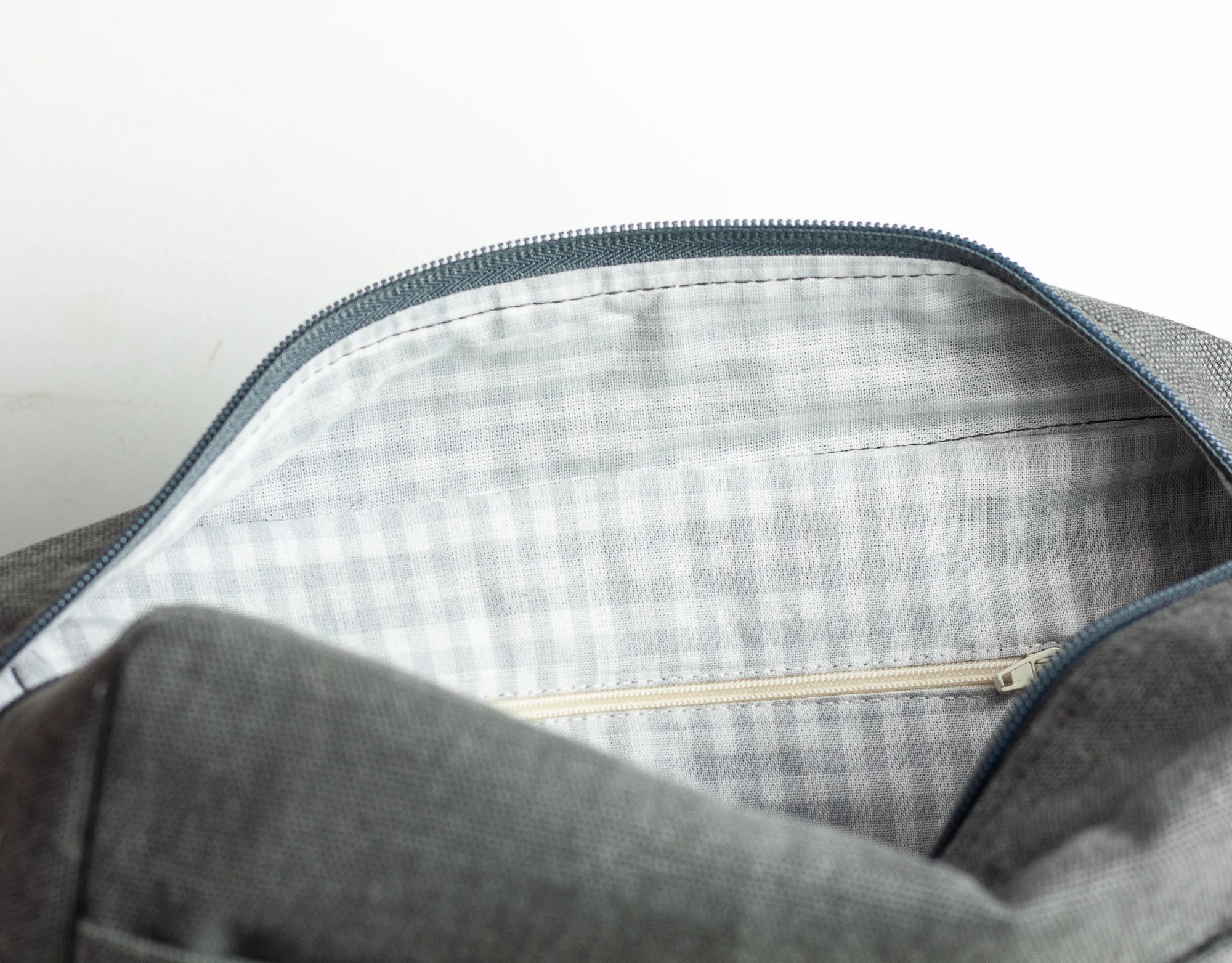 Gray bag with a zipper on a white background