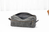 Gray toiletry bag with a zipper on a white background