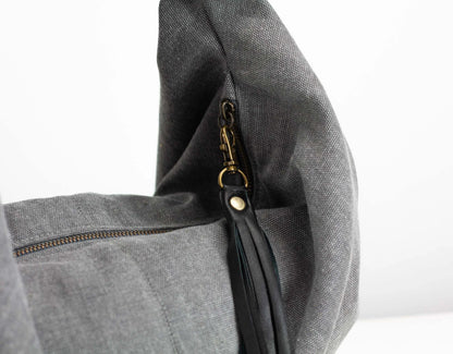 Gray bag with a zipper and gold clasp on a white background