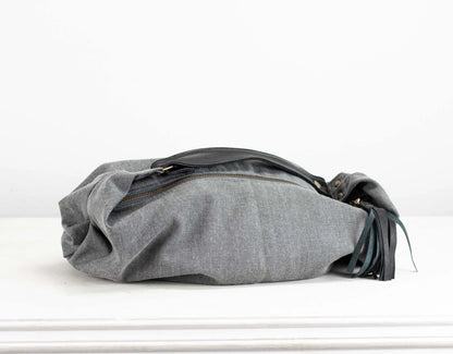 Gray fabric bag with black accents on a white background