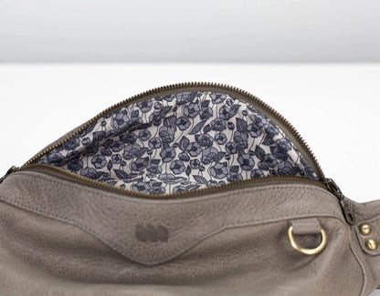 Gray leather bag with floral lining on a white background