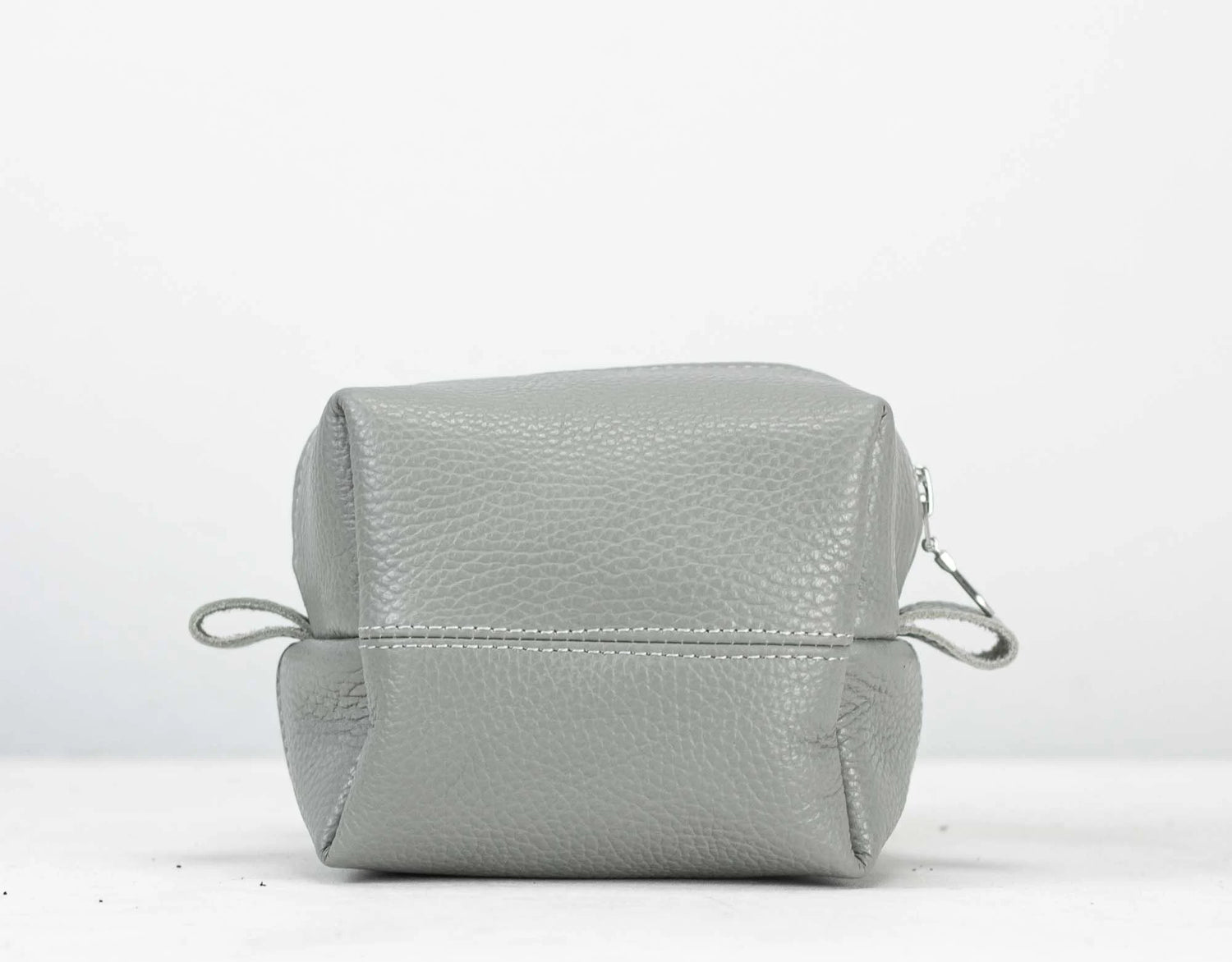 Light gray leather pouch on a white background