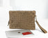 Beige woven clutch bag with a laptop and red book on a white background