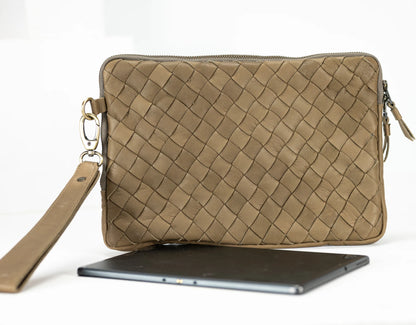 Beige woven clutch bag with a strap on a white background