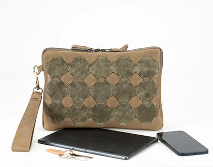 Brown clutch bag with geometric pattern, tablet, and phone on a white background