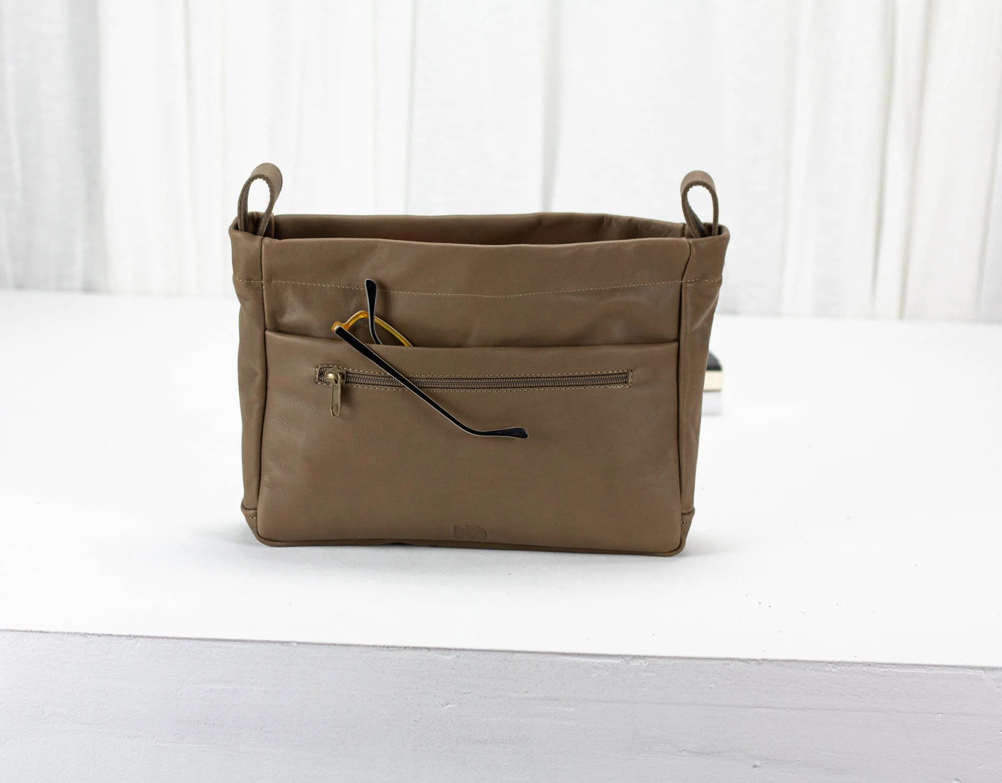 khaki Brown bag with a zipper on a white surface