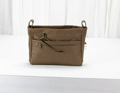 khaki Brown bag with a zipper on a white surface