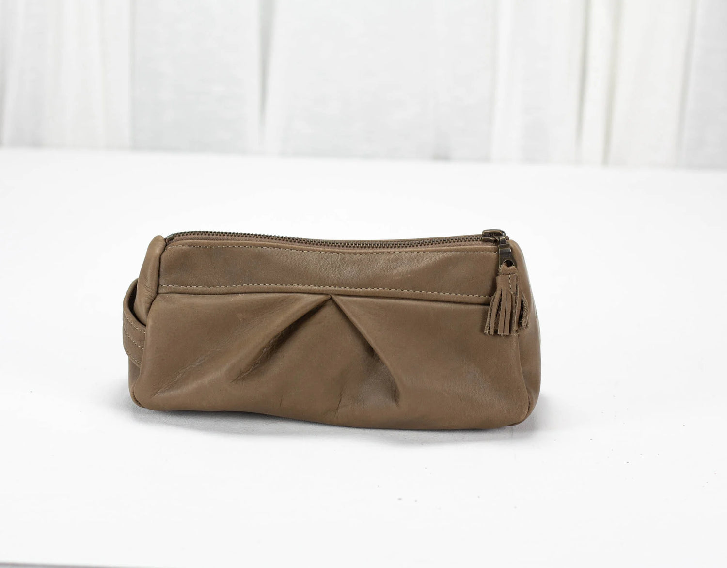 Brown leather clutch bag on a white background
