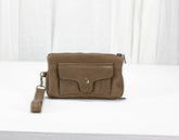 Brown leather wristlet with a strap on a white background