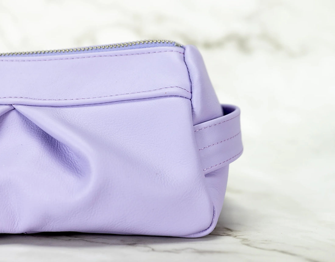 Purple pouch on a light marble background
