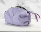 Purple pouch with a tassel on a white background