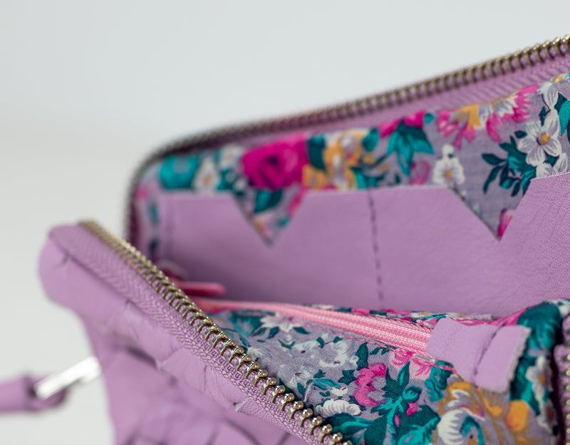 Floral-patterned wallet with a zipper on a light gray background