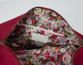 Floral-patterned interior of a bag with a visible brand label on a white background