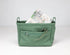 Green bag with a zipper pocket on a white background