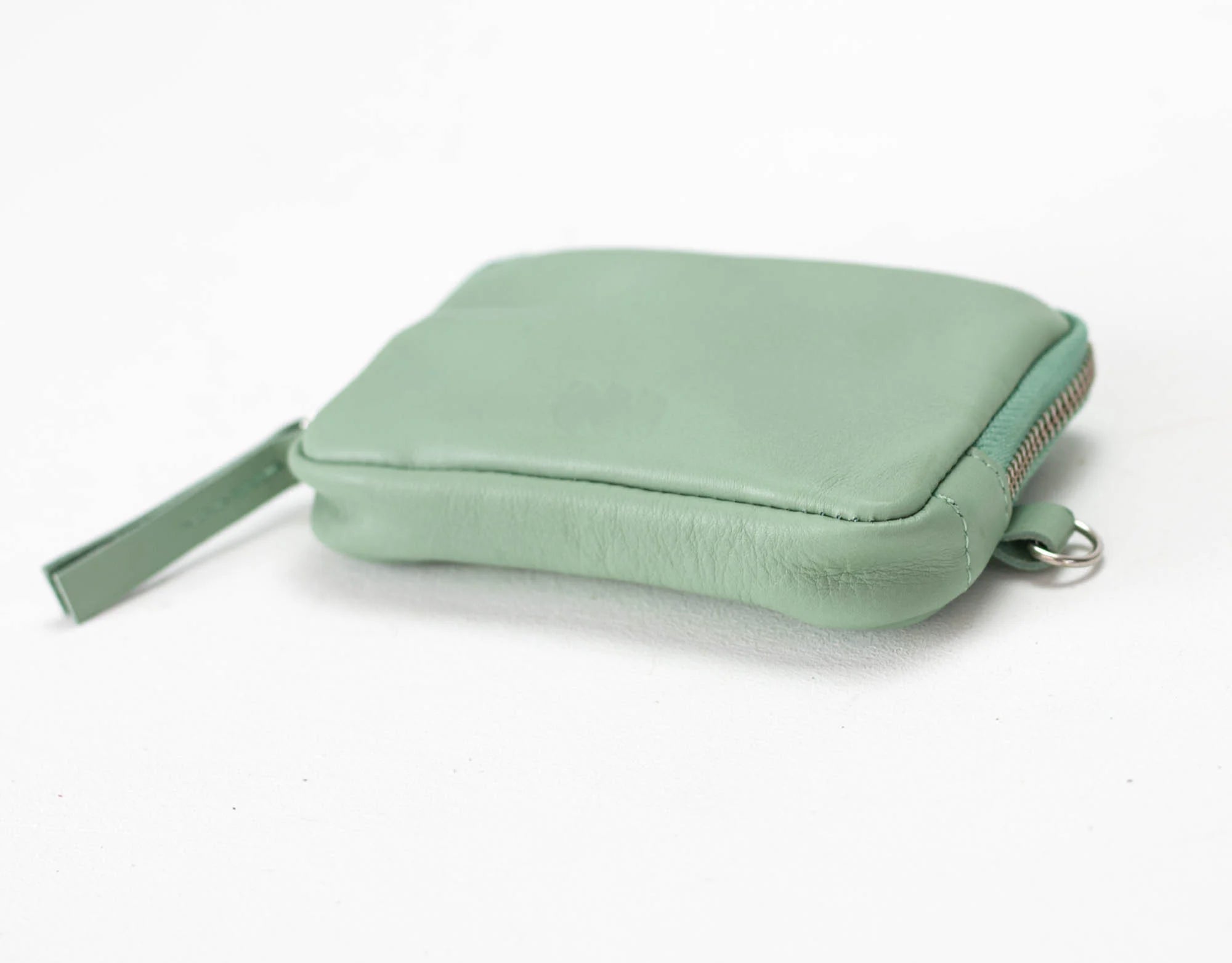 Mint green pouch with a strap on a white background