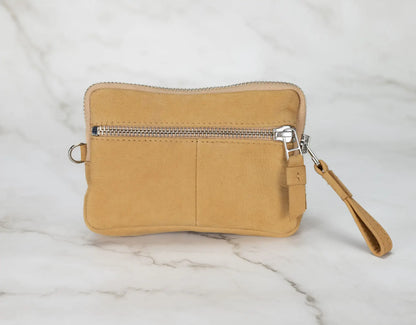 Beige wristlet with a zipper on a marble surface