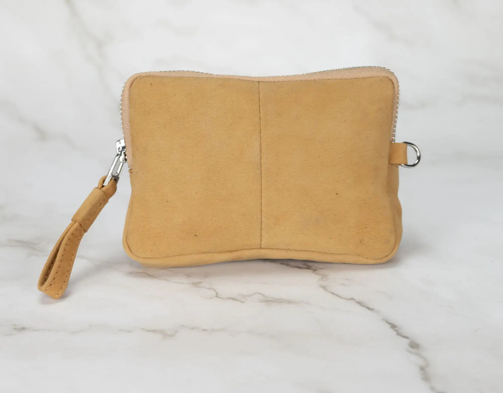 Beige pouch with a strap on a marble surface