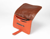 Brown leather clutch with orange interior on a white background