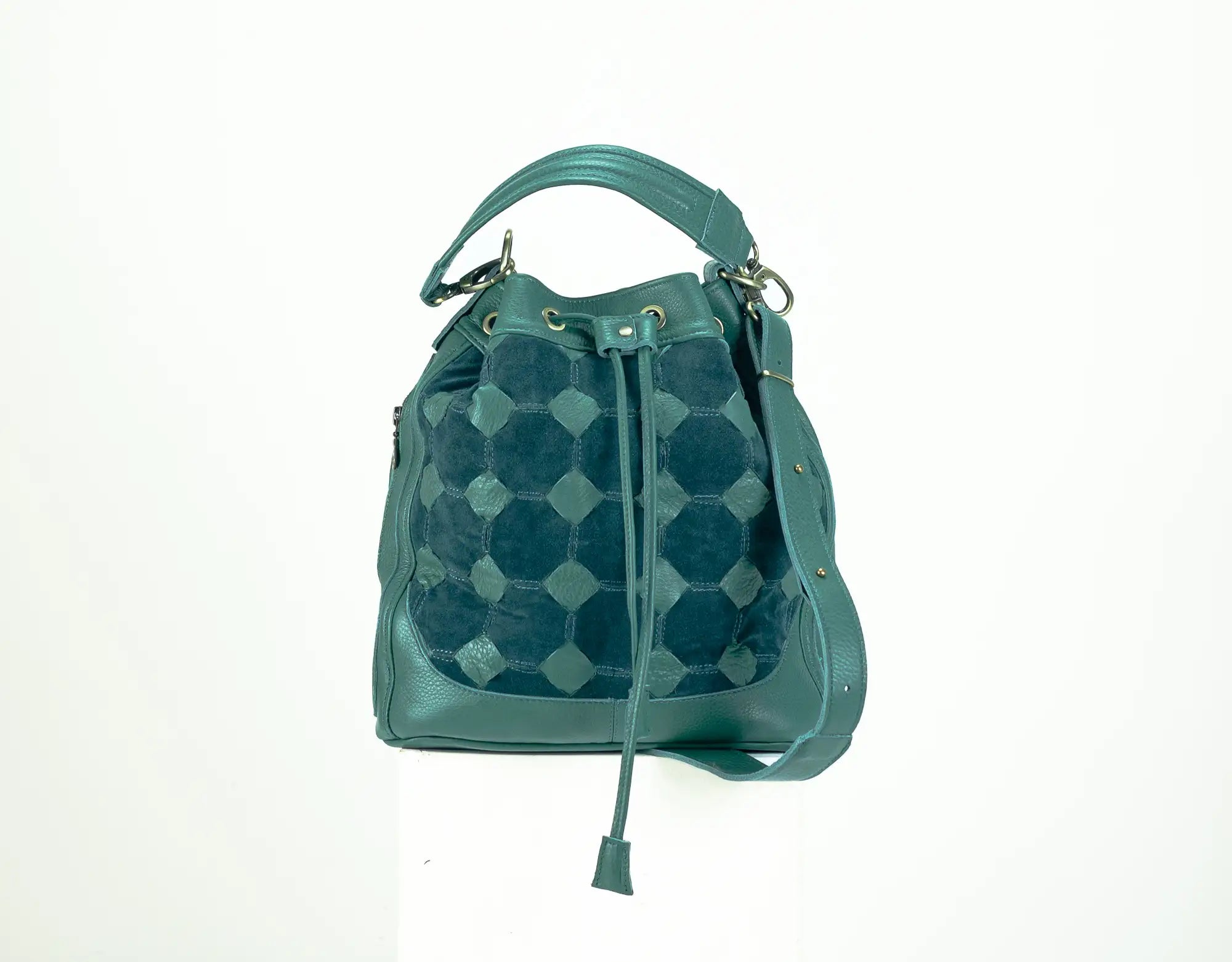 Teal patterned handbag on a white background
