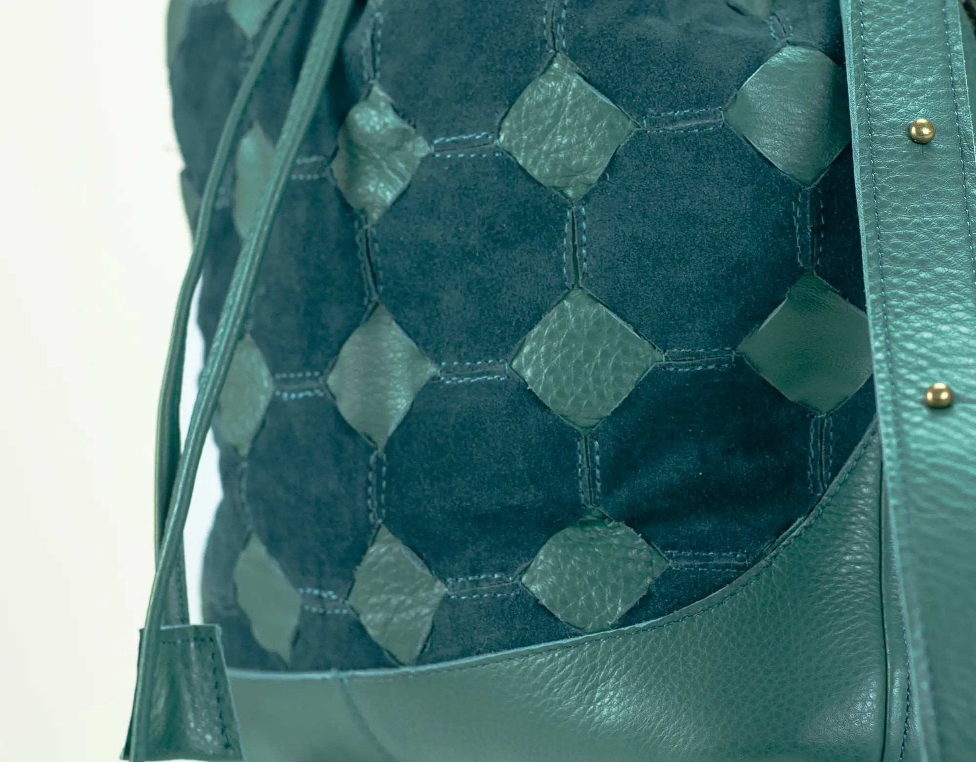 Green textured bag with geometric pattern on a light gray background