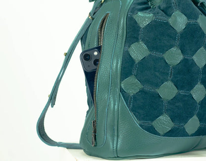 Teal quilted handbag with a visible brand logo on a white background