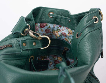 Green leather bag with floral interior on a white background