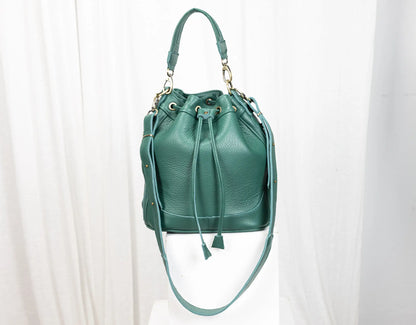 Green leather drawstring bag on a white background