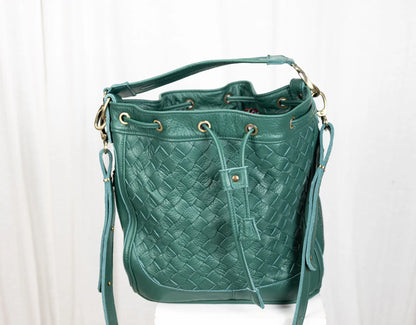 Green woven handbag on a white background
