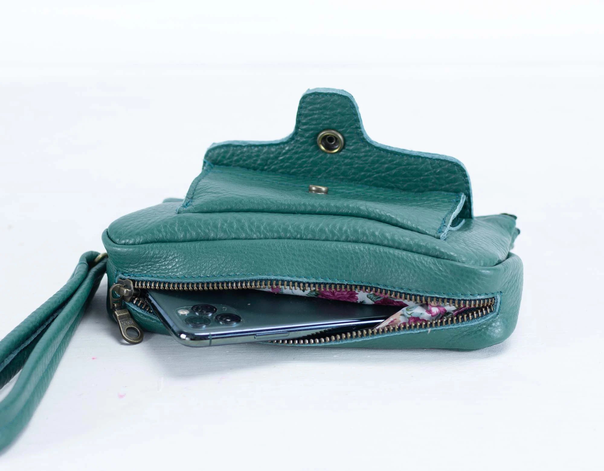 Teal leather wallet with a zipper on a white background
