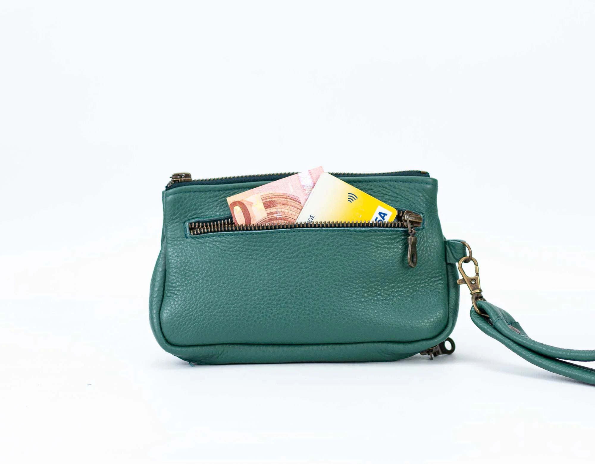 Green leather handbag with a strap on a white background