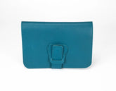 Teal clutch bag with a buckle on a white background
