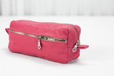 Pink cotton toiletry bag with a zipper on a white background