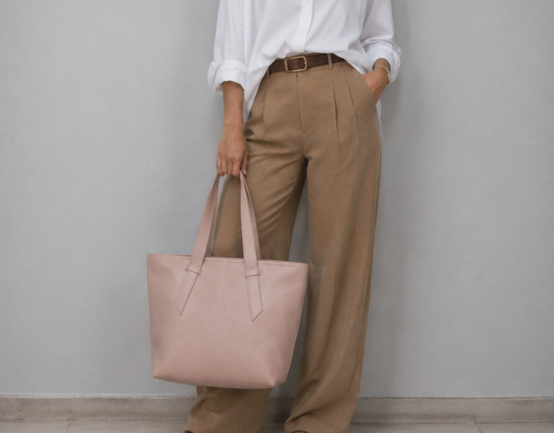 a woman holding a pink tote bag 