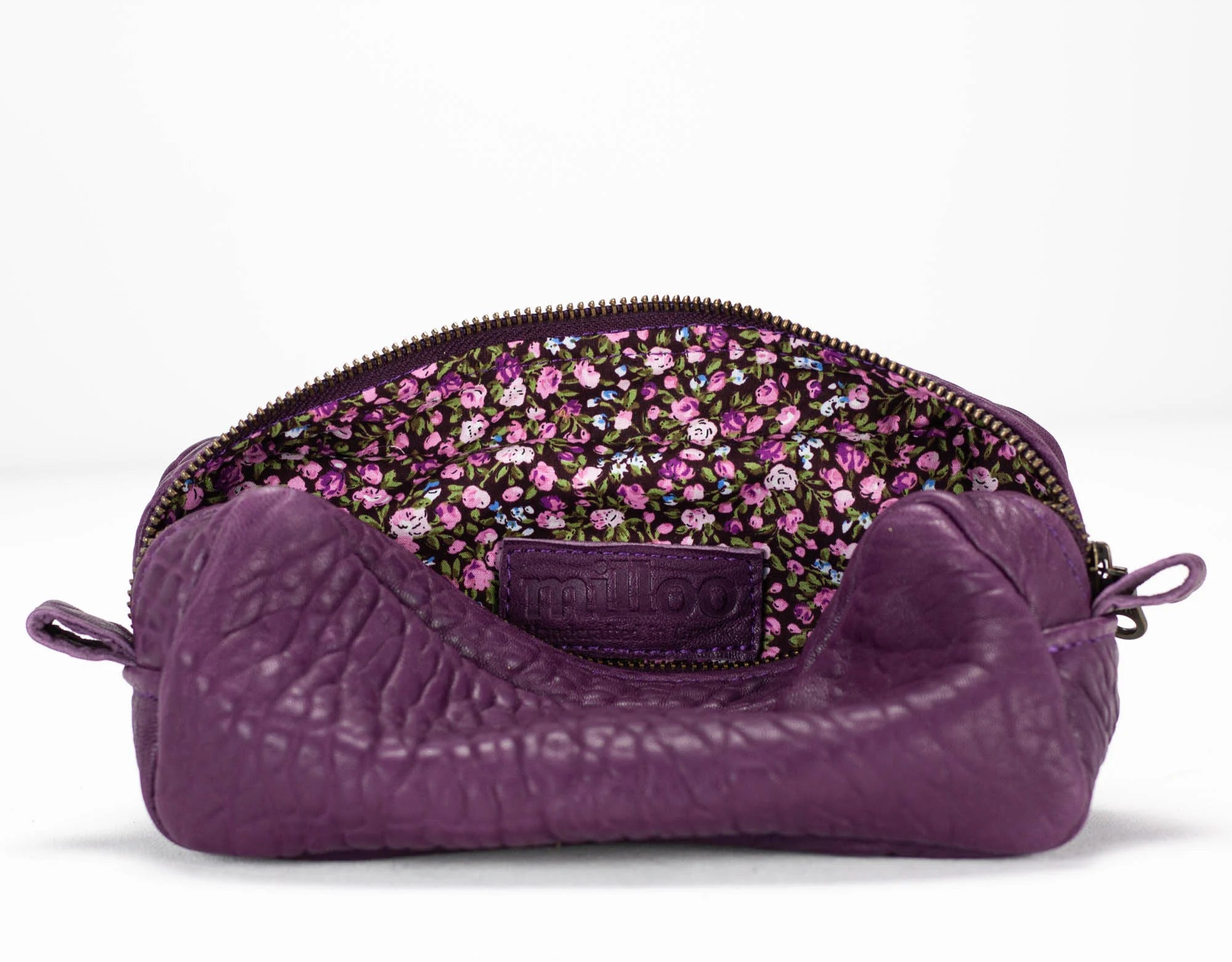 Purple textured pouch with floral patterned interior on a white background