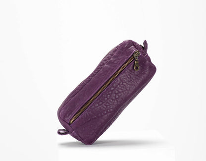Purple textured pouch with a gold zipper on a white background