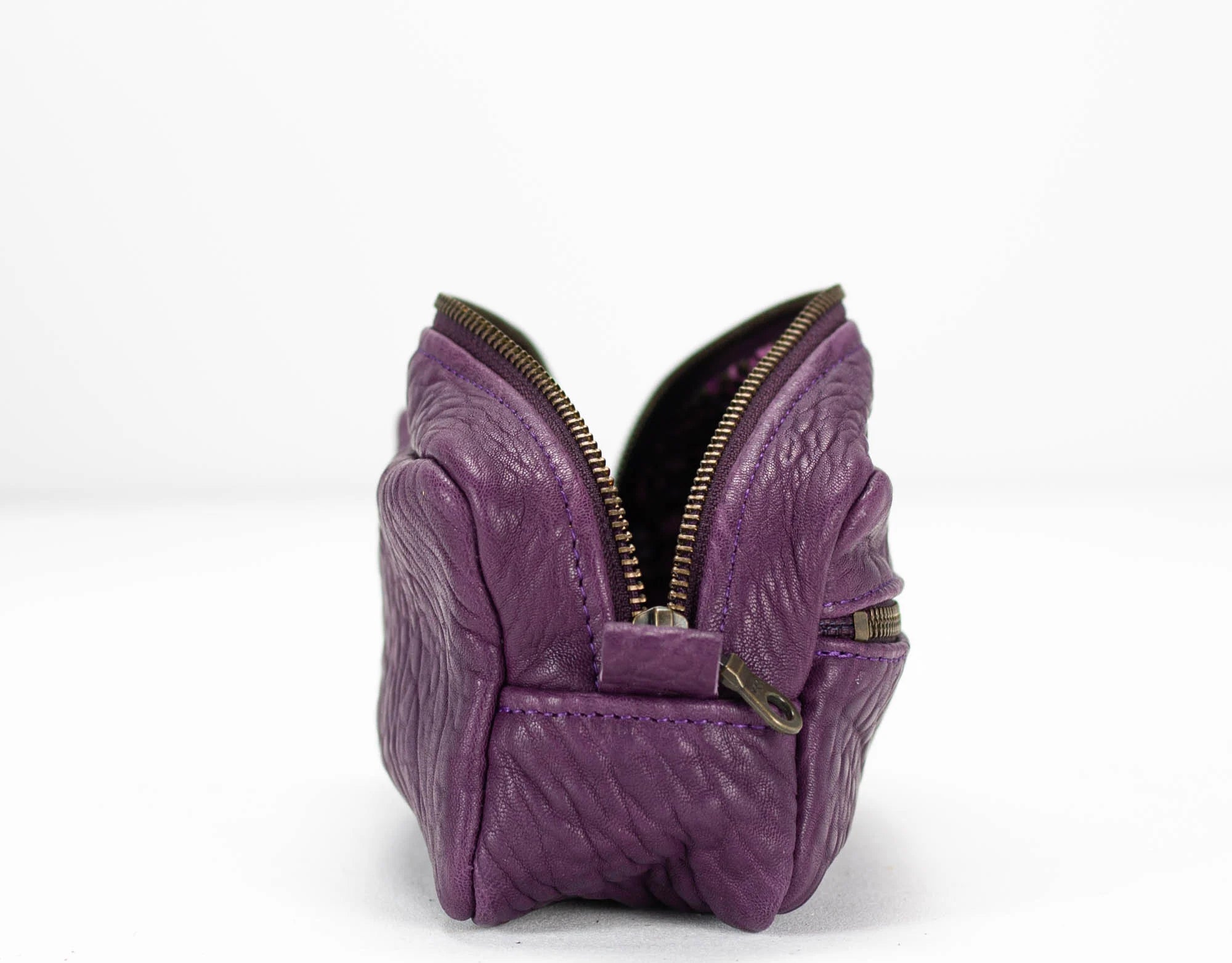 Purple butterfly-shaped purse with a zipper on a white background